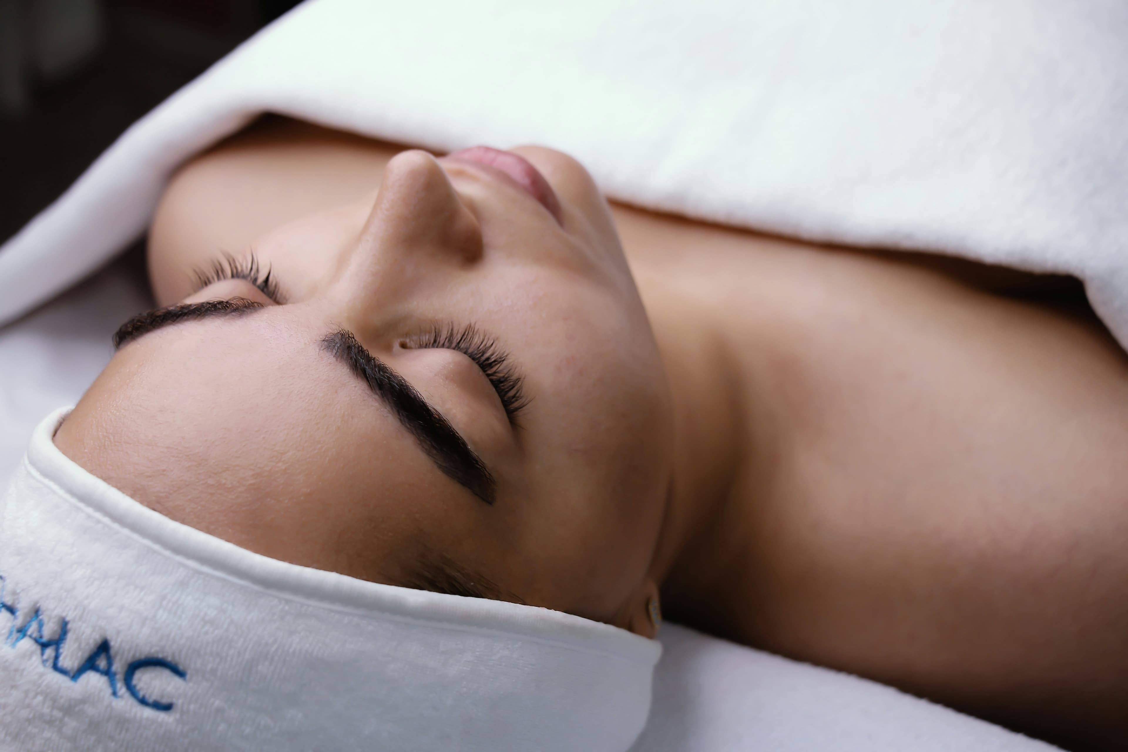 Karen Maria performing a holistic facial treatment in her Tenerife studio, blending skincare expertise with calming touch